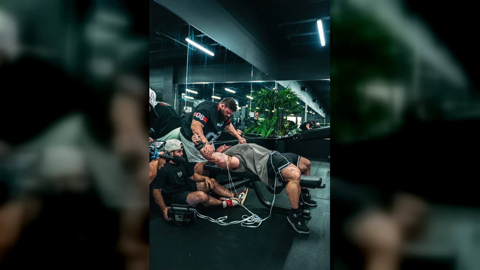 Jason providing hands-on recovery work with Derek Lunsford on the training floor at Champs Elysium