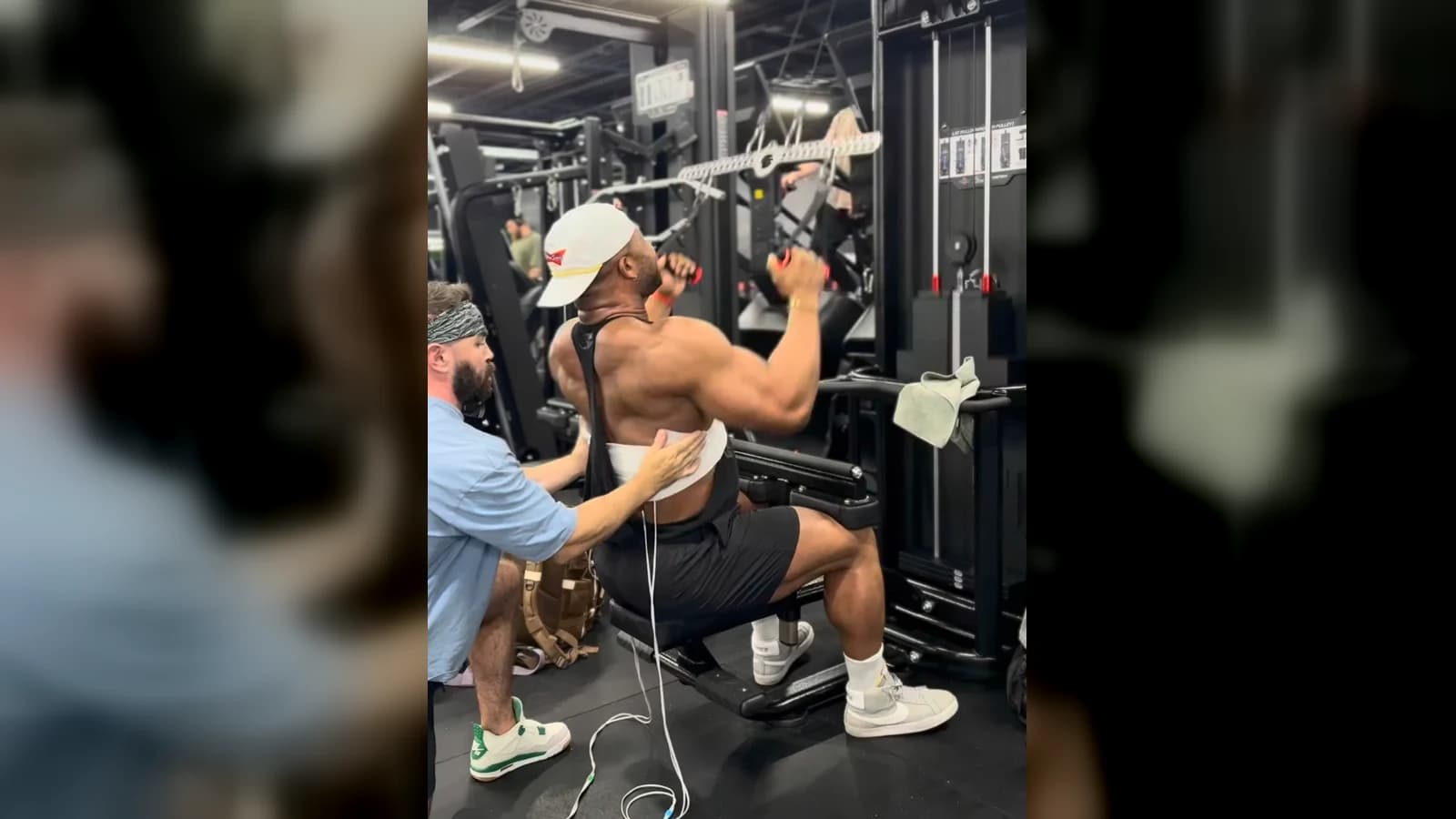 Jason supporting a bodybuilder through an electrically stimulated upper-body training set