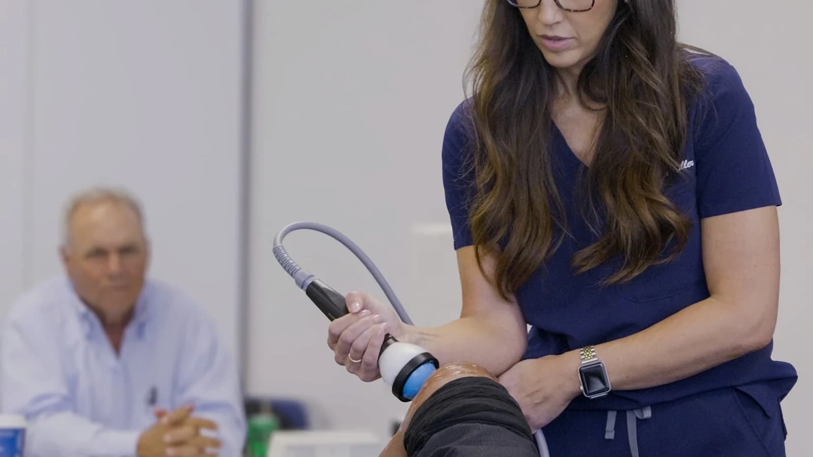 Focused acoustic-wave treatment being applied around the knee