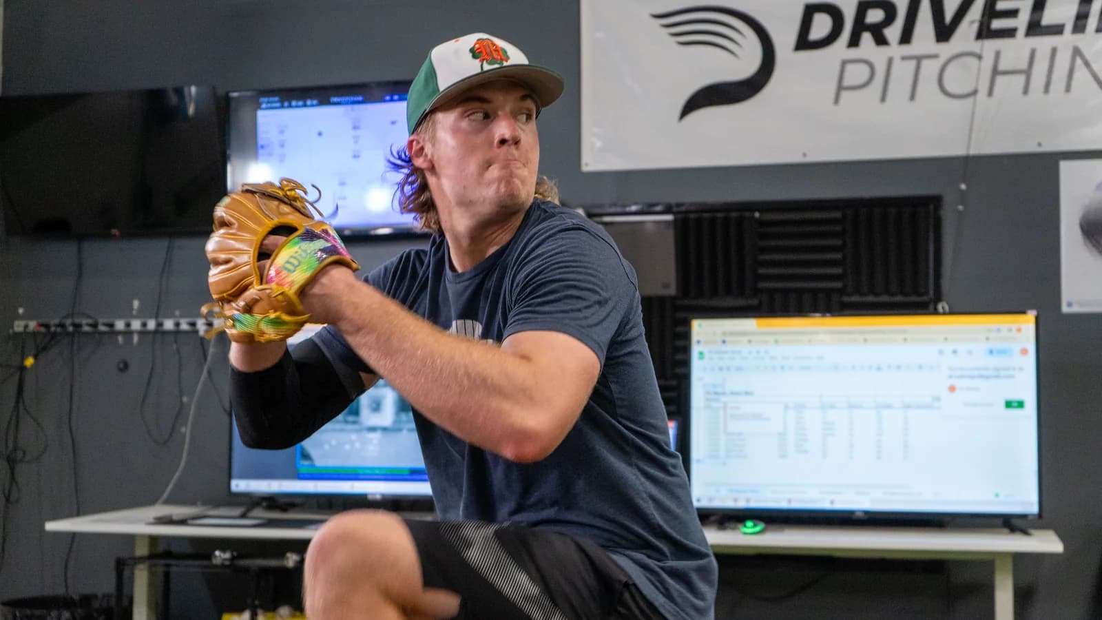 Pitcher completing a monitored throwing assessment in a data-enabled indoor mound environment