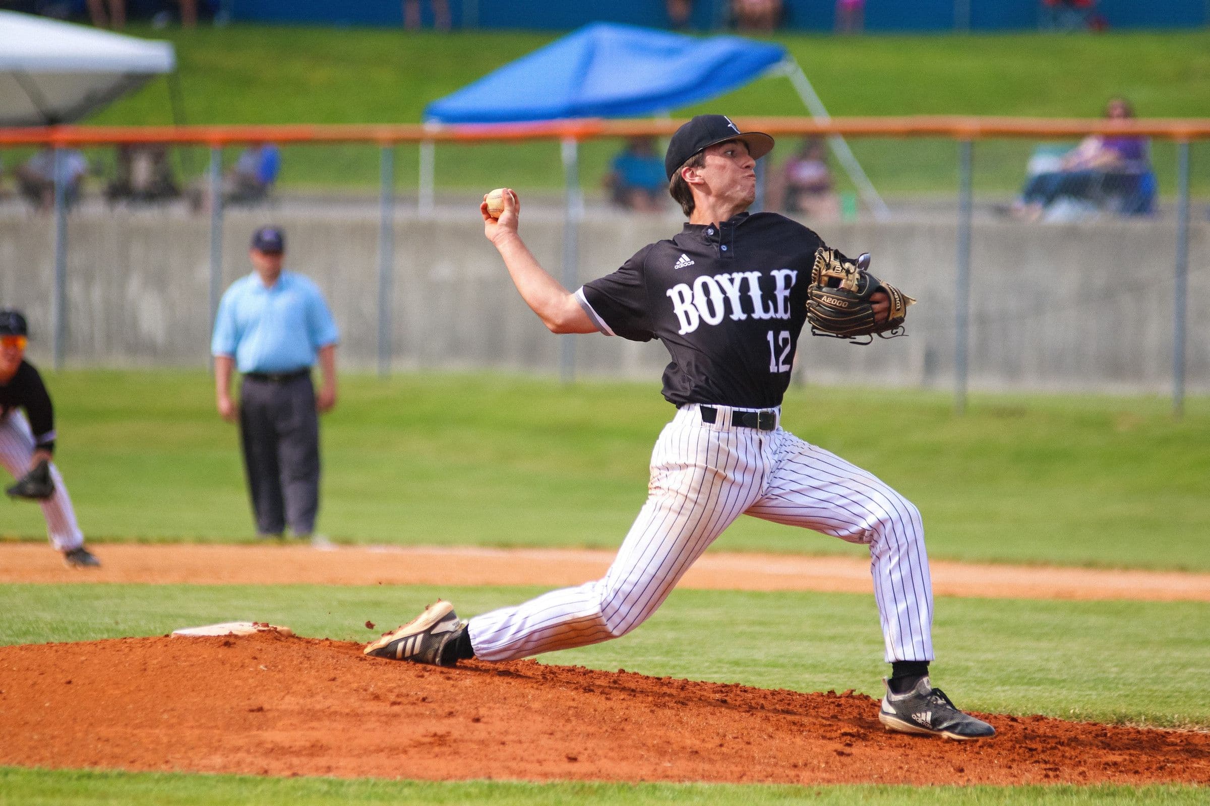 Youth baseball pitcher throwing from the mound during a game