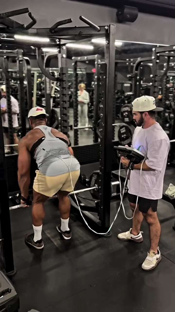 Bodybuilder completing a loaded lower-body set while Jason manages the ARPwave setup