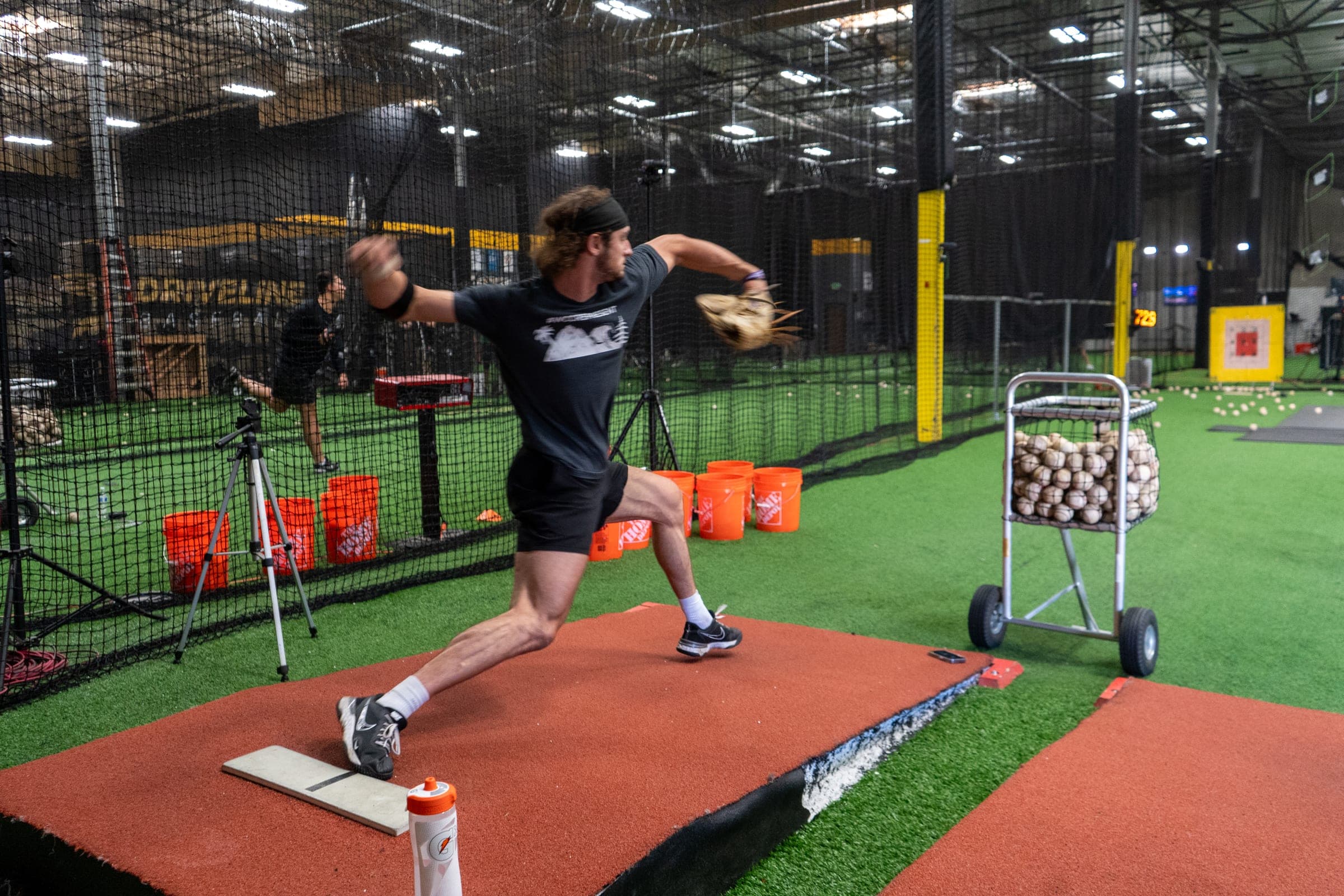 Pitcher progressing through a monitored return-to-throw session inside Driveline Baseball