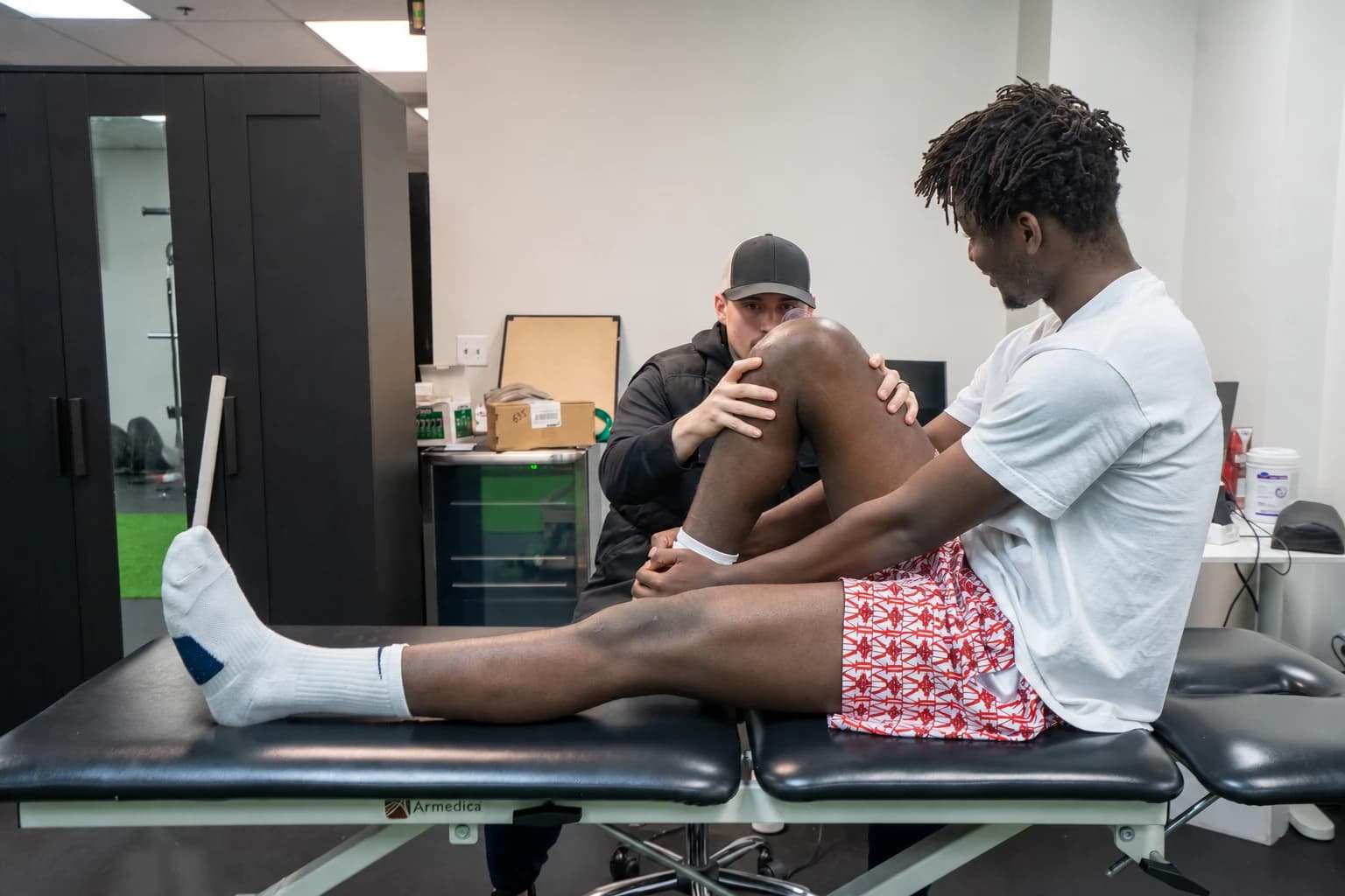 A physical therapist working with an athlete during active rehabilitation