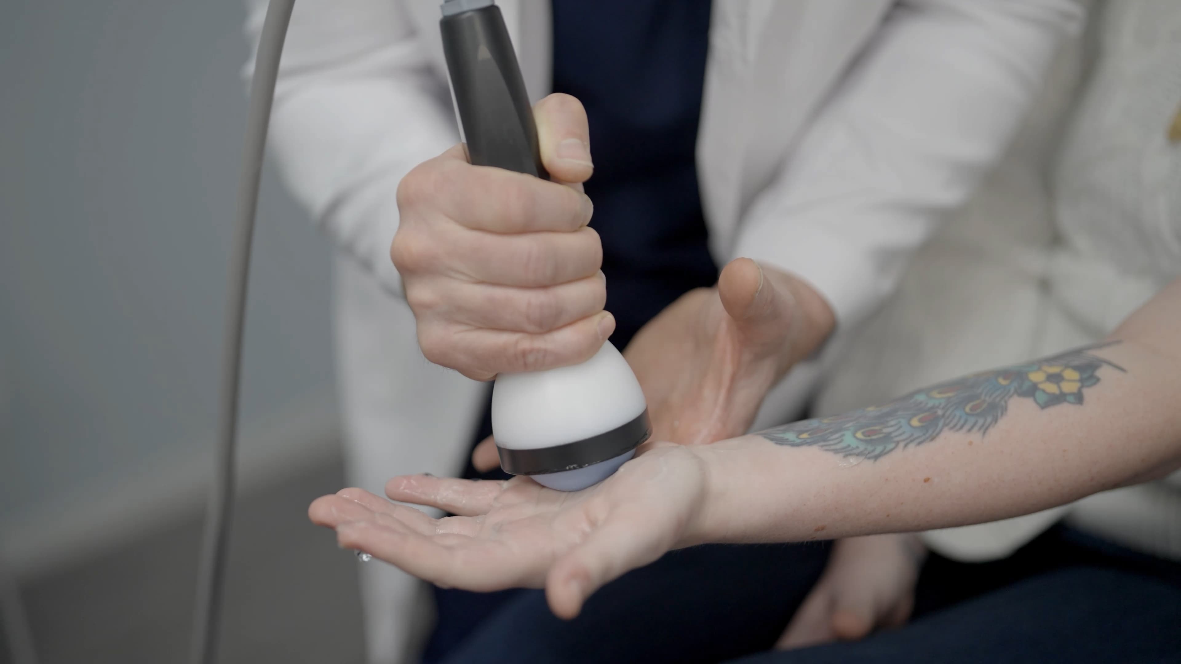 StemWave treatment being applied to the forearm near the elbow